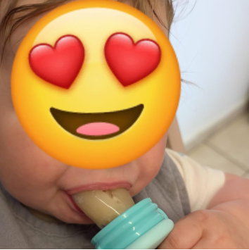 Child holding a popsicle with a heart-eyed emoji face superimposed over their head.